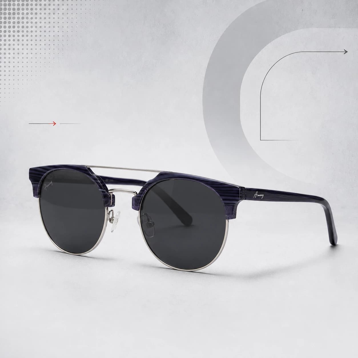 Black and gold browline sunglasses on a pale grey graphic background